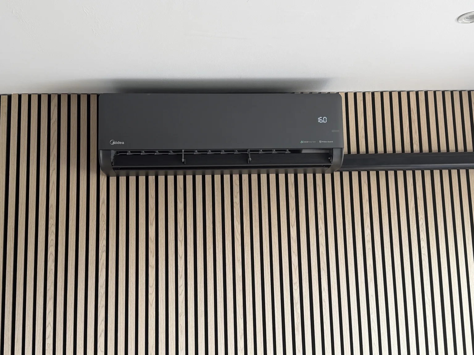 Black indoor air conditioning unit on a feature wall