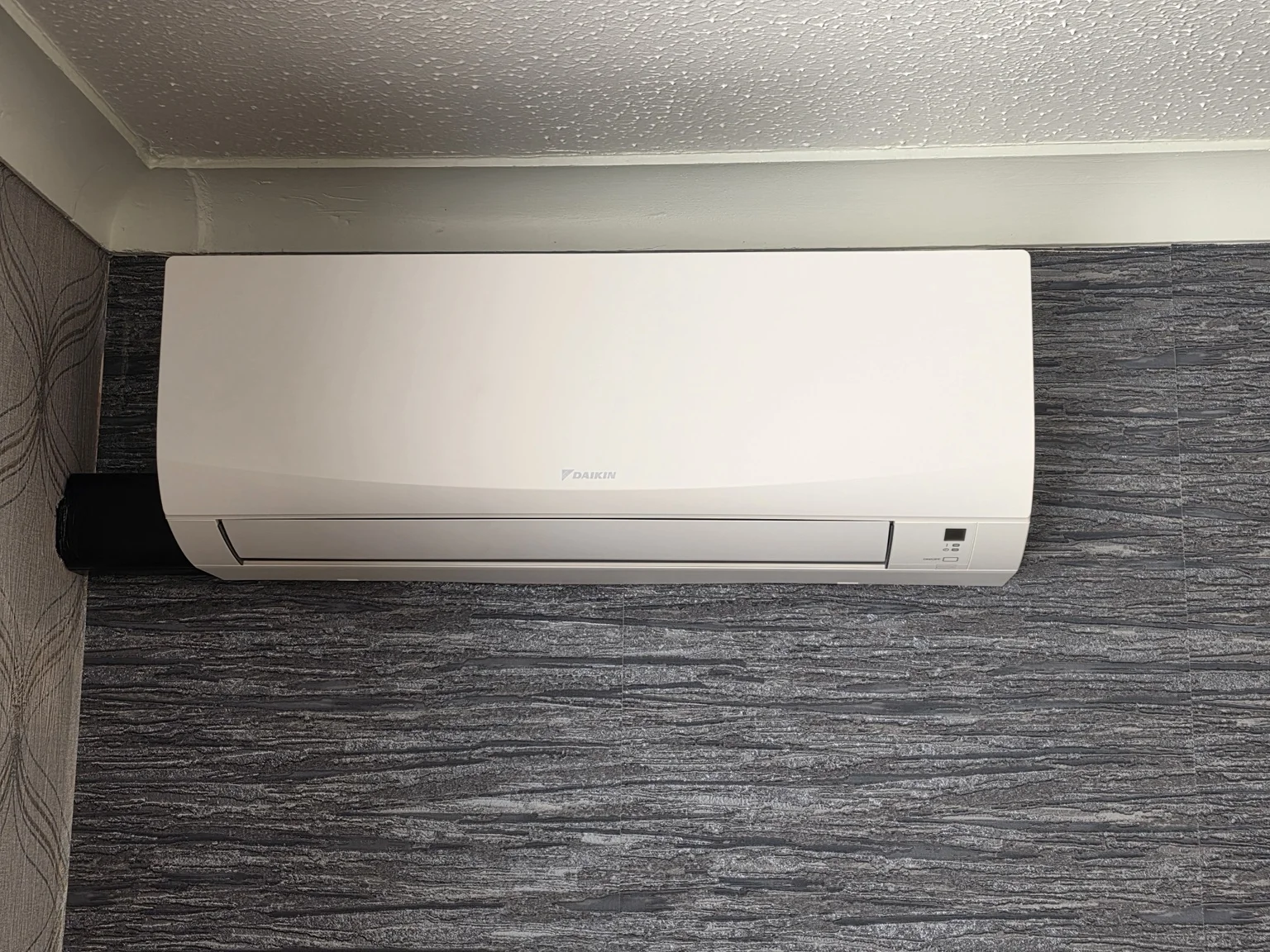 White wall-mounted indoor air conditioning unit