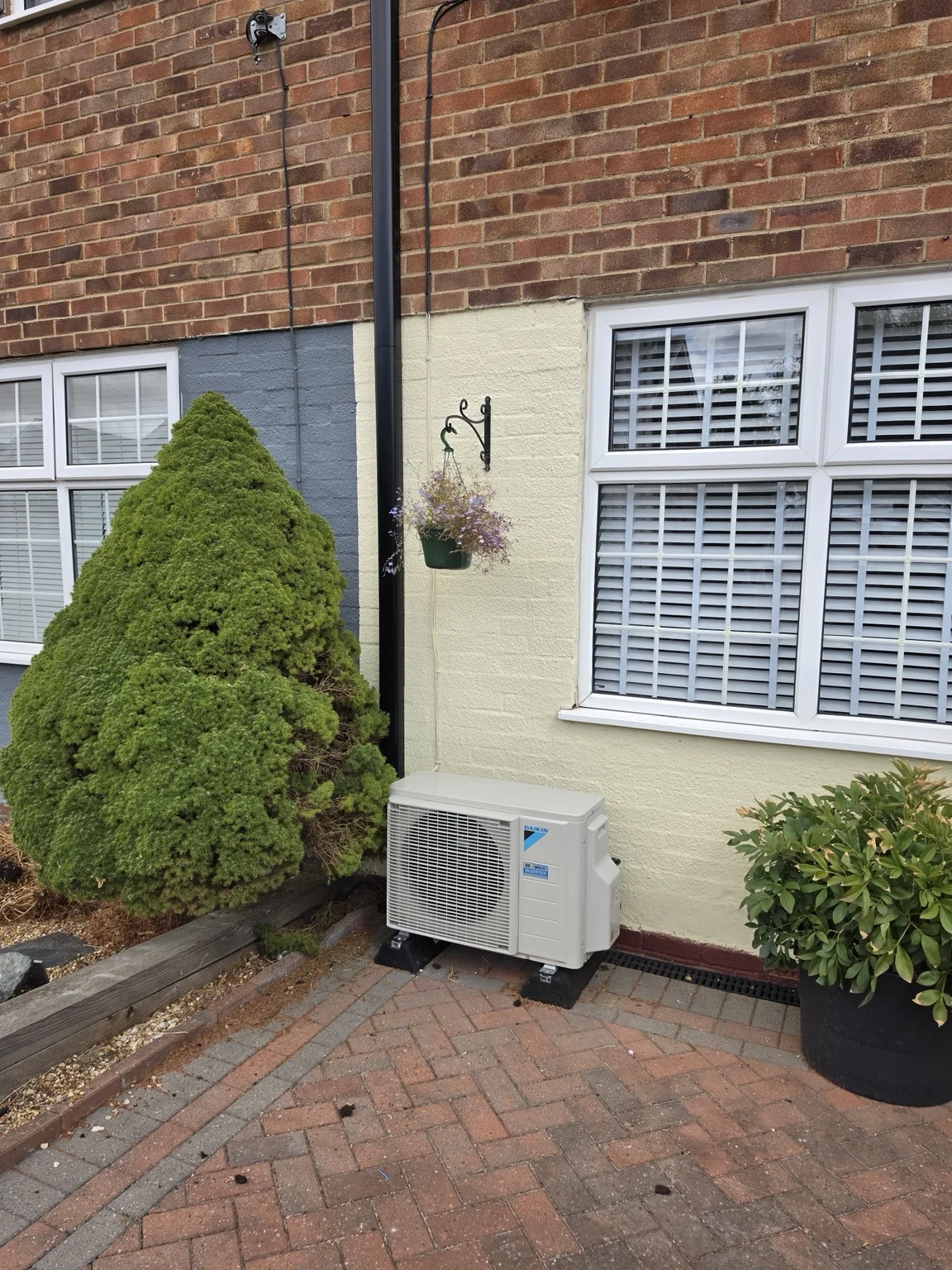 Air conditioning outdoor unit beside a house