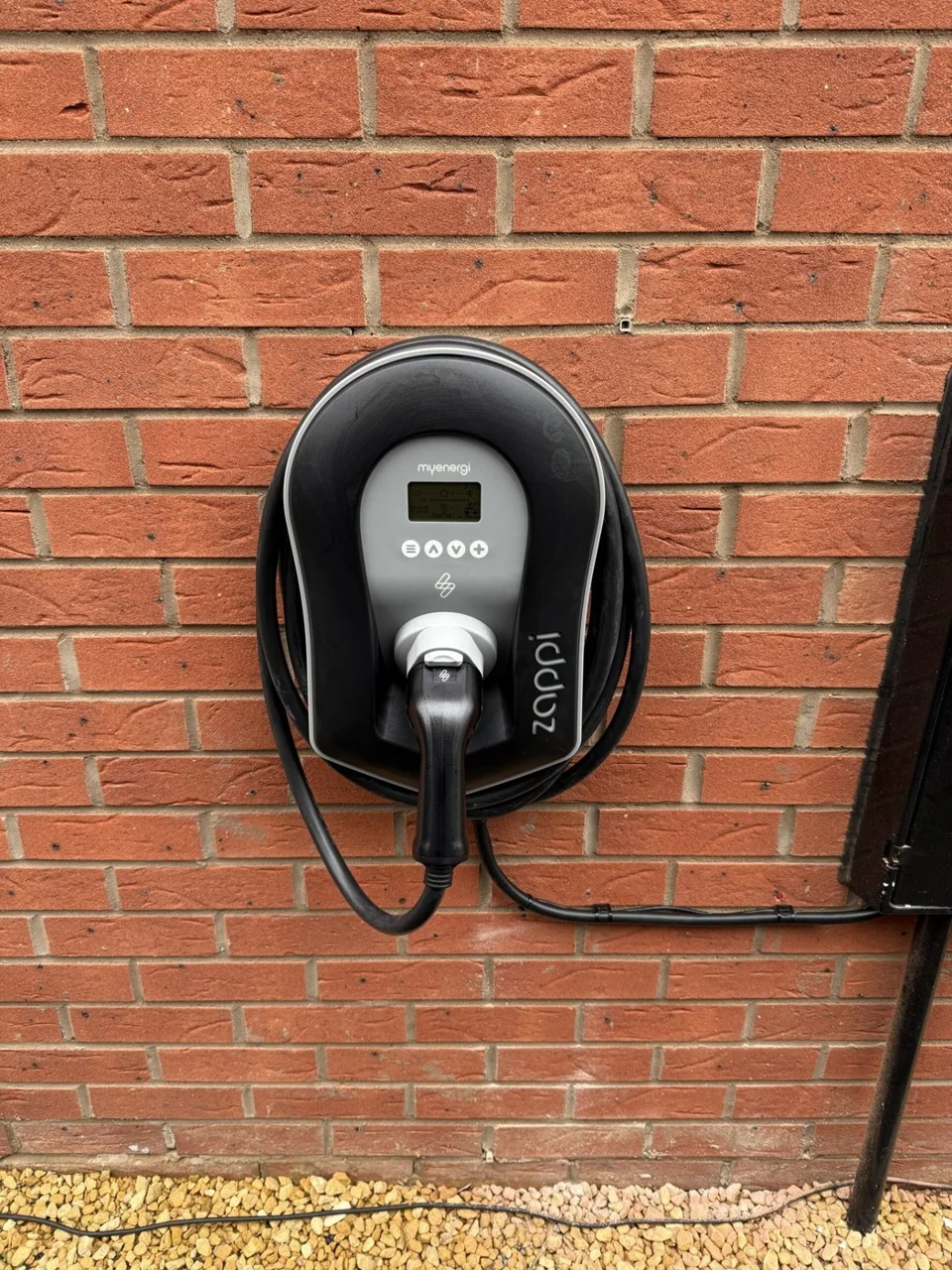 EV charger fitted to an external brick wall